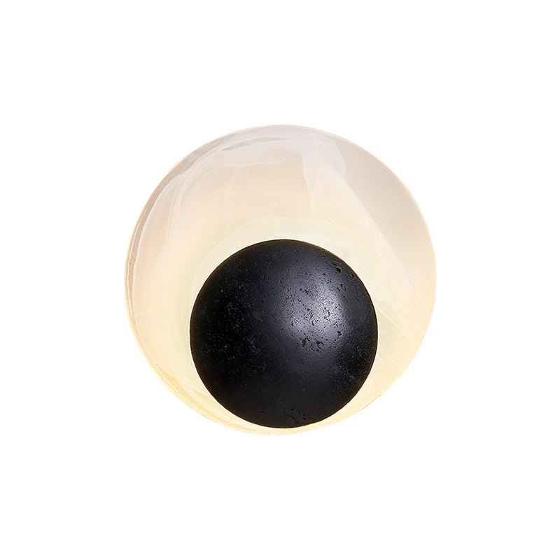 Orla Cosmica Eclipse Schwarze Travertin-Shell-Wandleuchte