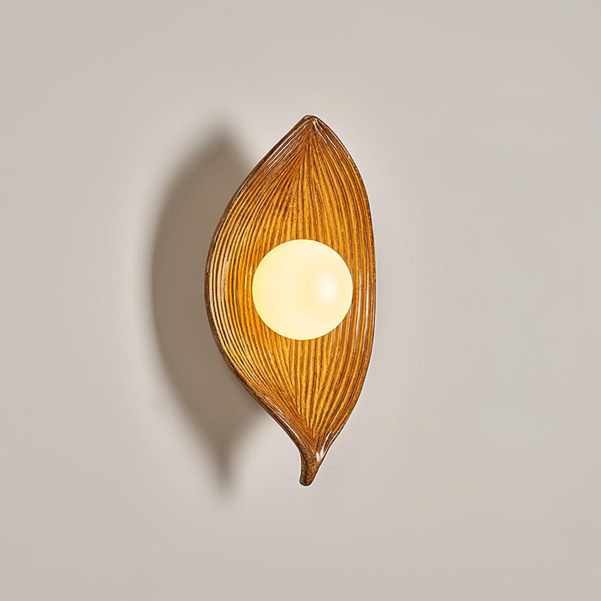 Lirixa Wandleuchte aus Kunstharz in Kieselsteinform